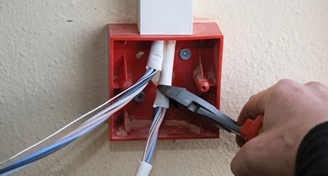 man cutting electrical wires