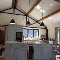 Home fitted with blue kitchen with long black drop down lights, Lakenheath