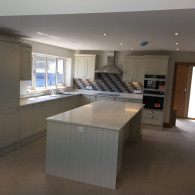 light grey kitchen with marble worktop